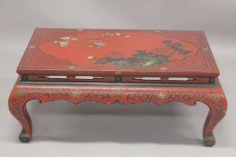 A CHINESE RED LACQUER AND CHINOISERIE DECORATED RECTANGULAR LOW TABLE decorated with flowers,