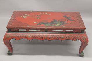 A CHINESE RED LACQUER AND CHINOISERIE DECORATED RECTANGULAR LOW TABLE decorated with flowers,