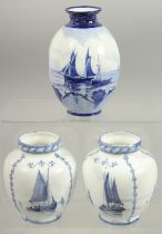 A ROYAL CROWN DERBY SET OF THREE VASES painted with sailing vessels by W.E.J. DEAN.