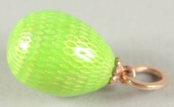 A 14CT GOLD RUSSIAN GREEN EGG PENDANT with a snake.