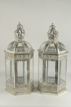 A PAIR OF SILVERED METAL HEXAGONAL SHAPE HANGING LANTERNS. 2ft high.