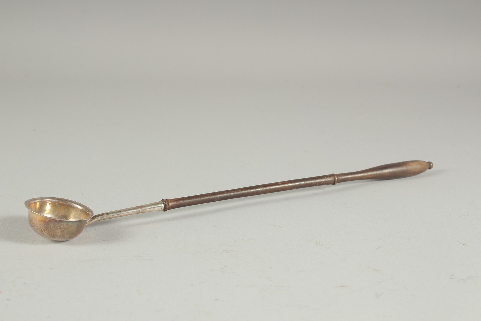 A GEORGE III SILVER TODY LADLE with wooden handle. Edinburgh, circa. 1800.