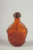 A CARVED AMBER SNUFF BOTTLE AND STOPPER. 3ins long.
