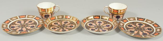 TWO ROYAL CROWN DERBY COFFEE CUPS, SAUCERS AND SIDE PLATES. Pattern no. 1128.