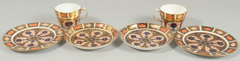 TWO ROYAL CROWN DERBY COFFEE CUPS, SAUCERS AND SIDE PLATES. Pattern no. 1128.