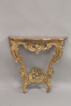 AN 18TH CENTURY ITALIAN GILTWOOD AND MARBLE CONSOLE TABLE, the veriagated marble serpentine top