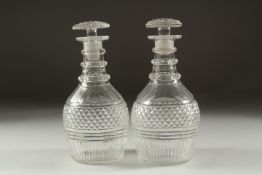 A PAIR OF GEORGIAN HOB NAIL CUT DECANTERS AND STOPPERS.