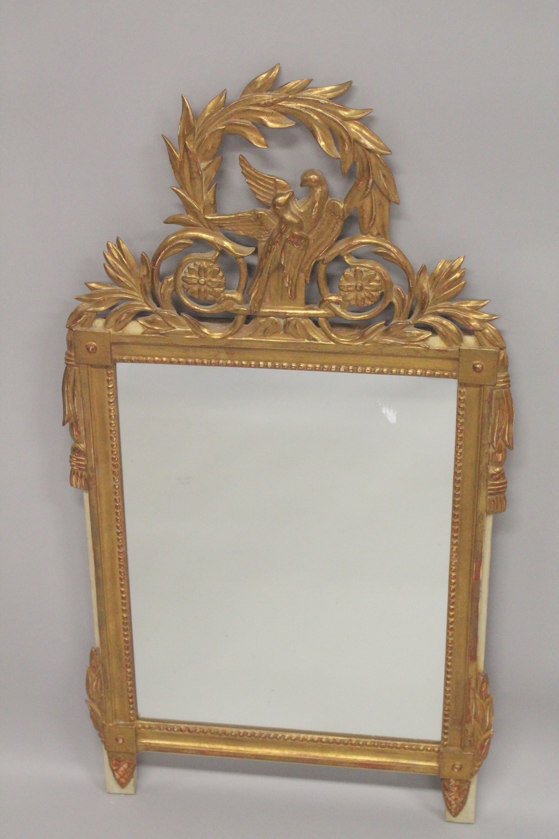 A GOOD ITALIAN GILTWOOD MIRROR with two love birds and foliage. 3ft 4ins high, 1ft 8ins wide.
