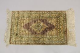 A PERSIAN SILK AND WOOL TEXTILE 41ins x 24ins.