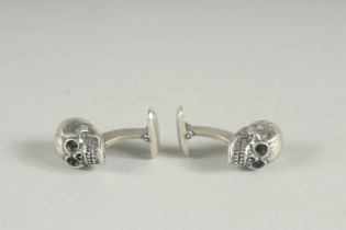 A PAIR OF HALLMARKED SILVER SKULL CUFF LINKS.