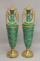 A LARGE AND IMPRESSIVE PAIR OF MALACHITE AND ORMOLU FLOOR STANDING URNS. 4ft 4ins high.