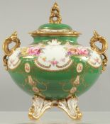 A FINE ROYAL CROWN DERBY VASE AND COVER painted with flowers above a green ground by A.F. WOOD.