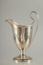 A GEORGE III SILVER HELMET SHAPED CLARET JUG. London 1790. Maker: Robert Hennel.