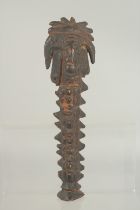 AN EARLY CARVED WOOD IDOL. 10ins long.
