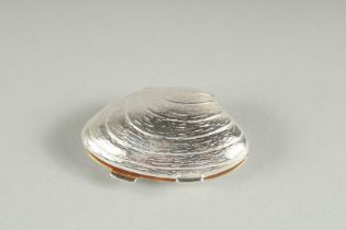 A STERLING SILVER CLAM SHELL PILL BOX with gilded interior.