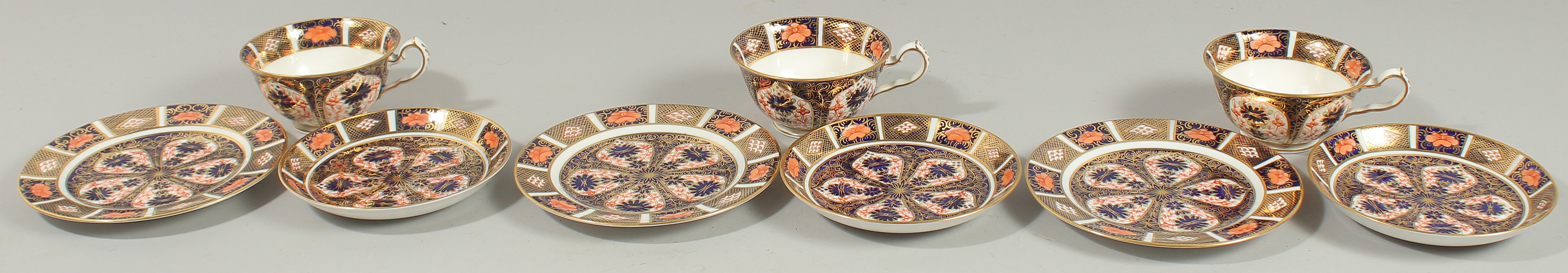 THREE ROYAL CROWN DERBY TEA CUPS, SAUCERS AND SIDE PLATES. Pattern no. 1128.