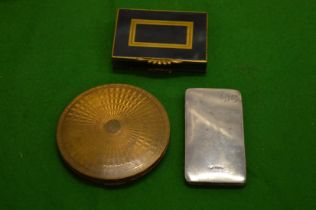 A silver case and two compacts.