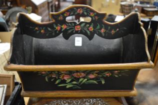 A floral painted wooden cutlery carrier.