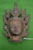 A small bronze head of an Eastern Deity.