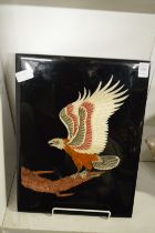 A lacquer plaque depicting an eagle on a branch.