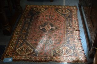 A small Persian rug, pink ground with stylised decoration 160cm x 112cm.