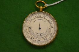 A pocket combination barometer and thermometer.