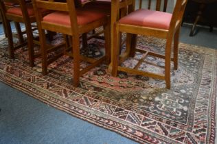 A Persian carpet, pink ground with stylised decoration 265cm x 165cm.