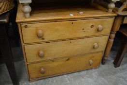 A pine three drawer chest.