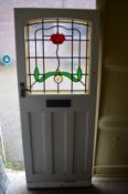 An external door with stained glass leaded light panel.