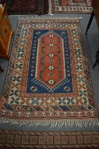 A Persian rug, blue ground with geometric design 180cm x 115cm.