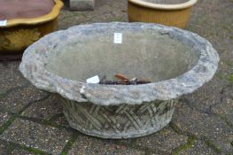 A reconstituted stoneware basket weave style planter and shallow bird bath.