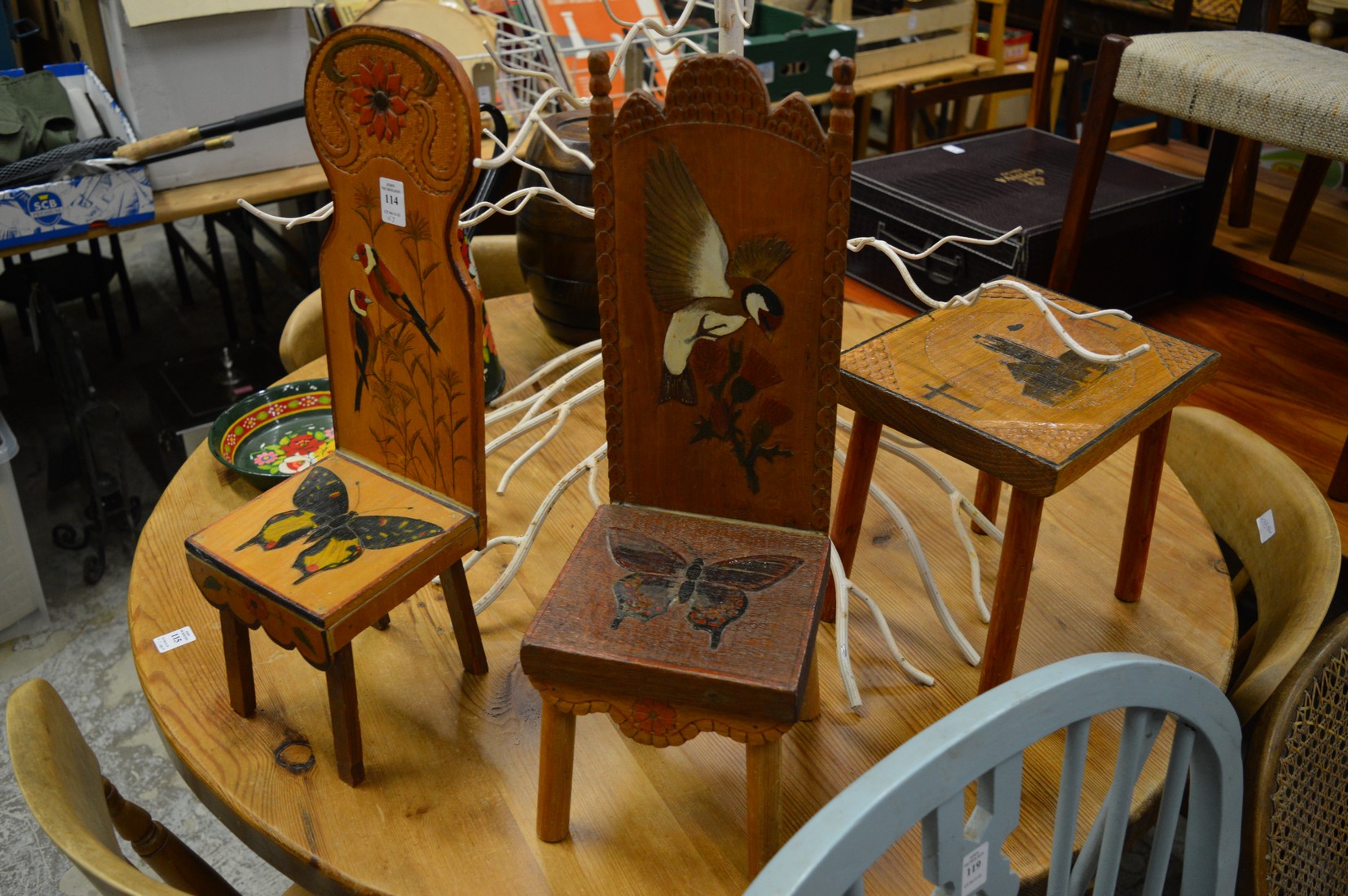 Two decorative small wooden chairs and a similar table.