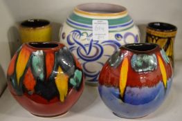 A pair of small Poole pottery volcano vases together with other Poole pottery vases.