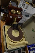 An old style wall mounted telephone and an early record player.