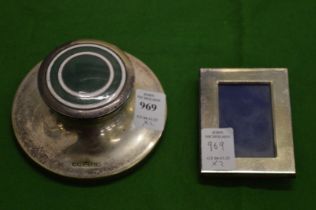 Silver plated ink stand and a small silver photograph frame.