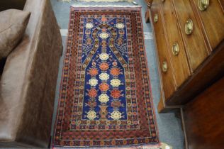 A good Persian prayer, blue ground with stylised floral decoration 145cm x 78cm.