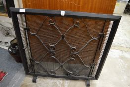 A wrought iron fire screen.