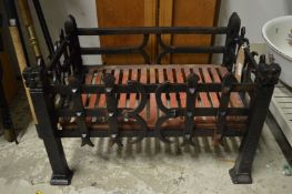 A wrought and cast iron fire basket.