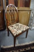 A mahogany single dining chair.