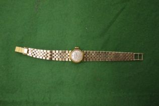 A Ladies Rolex 18ct gold wristwatch with 18ct gold curb link bracelet strap.