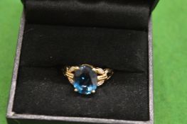 A gold and gem set ring.