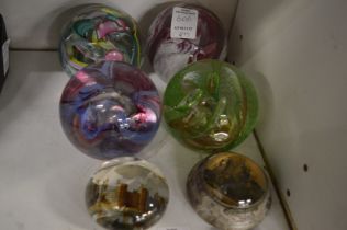 Six glass paperweights.