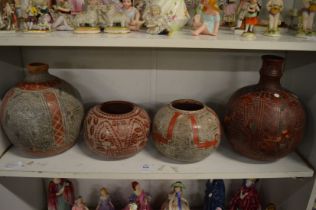 A group of four incised pottery vases signed Daniel.