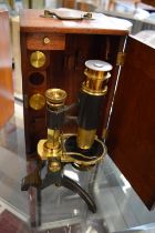 A Pickard & Curry brass microscope with mahogany case.