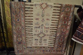 An unusual coarse woven tribal rug depicting animals and geometric motifs 205cm x 105cm.