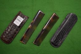 Leather cased combs.