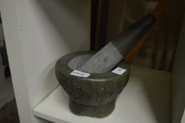 A stone pestle and mortar.