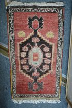 A small Persian rug, 93cm x 50cm.
