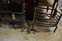 Two wrought iron fire baskets and a pair of fire dogs.