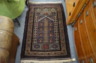 A Persian prayer rug blue ground with stylised decoration 145cm x 88cm.